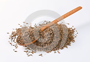 Pile and spoon of caraway seeds