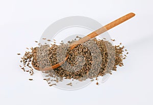 Pile and spoon of caraway seeds