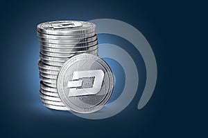 Pile or stack of silver Dash coins on a gently lit dark background