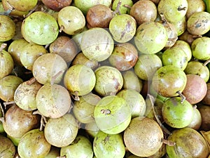 Pile of star apples or chrysophyllum cainito sold in Banyuwangi traditional market,  Indonesia