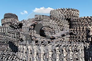 A pile of steel tracks combat Soviet tanks against the blue sky.