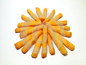 A pile of stick chips in a room with white background