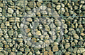 Pile of stones behind metal grid.