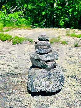 A pile of stones cairn marker on iron trail