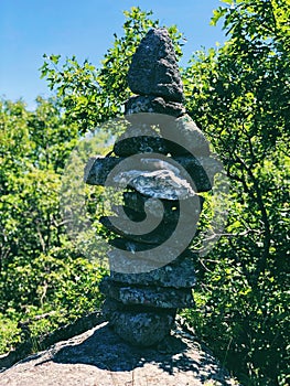 A pile of stones cairn marker on iron trail