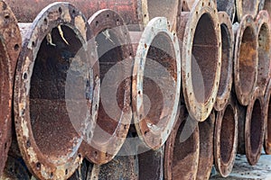 A pile of stored dredging pipes close up with selective focus