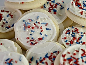 Pile of sugar cookies with white frosting and red, white and blue sprinkles for the 4th of July, Memorial Day, Veterans Day and