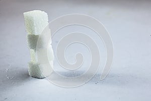 Pile of Sugar Cubes Stacking on Isolated White Background with Harsh Shadow, which can be used to imply dark side of Sugar.