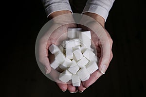 A pile of sugar in a woman`s hands