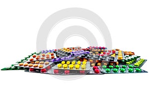 Pile of tablet pills isolated on white background. Yellow, purple, black, orange, pink , green tablet pills in blister pack. Pain