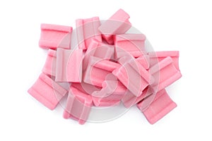 Pile of tasty pink chewing gums on white background, top view