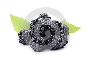 Pile of tasty ripe blackberries with green leaves on white