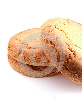 Pile of three ginger nut biscuits one at the side