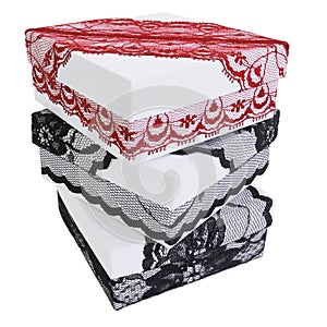 Pile of three stylish white gift boxes, decorated with exquisite black and red lace ribbon