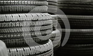 Pile of tires stack in warehouse waiting to transport to distributors, new car tyres product in manufacturing factory background