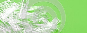 Pile of transparent plastic wrapping rubbish on a green background
