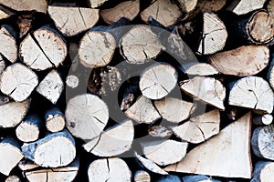 Pile of tree trunks with blurred background. Shallow focus on the tree trunks.