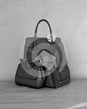 Pile of trendy leather handbags. black and white image