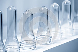 The pile of tube preform shape plastic bottles .