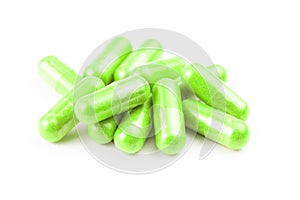 Pile of ufo green organic capsules isolated on white background closeup with selective focus