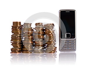 Pile of UK coins against mobile phone