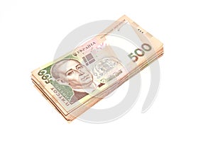 A pile of Ukrainian money for five hundred hryvnia isolated on a white background. Top view, copy space