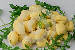 Pile of Uncooked Gnocchi with arugula