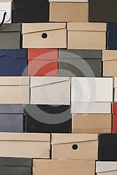 Pile of uniformly folded shoe boxes of different colors can be used as a background or wallpaper. Seasonal sales and discounts