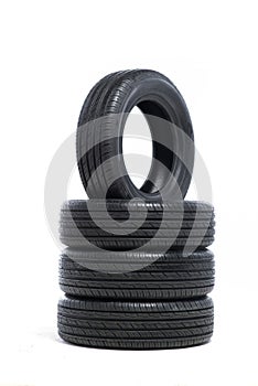 Pile of unused car tires on white background