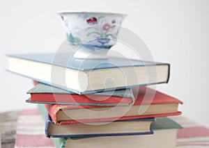 Pile of used books with teacup