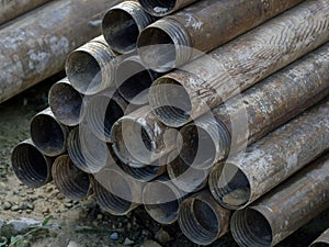 pile of used drilling pipes