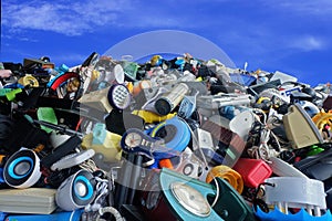 Pile of used Electronic and Housewares Waste Division broken or damage with blue sky and clouds background