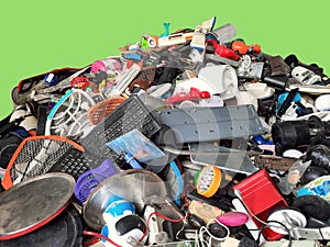 Pile of used Electronic and Housewares Waste Division broken or damage with green background, E-waste for Reuse and Recycle and is photo
