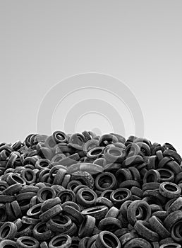 Pile of used rubber tyres on gray background