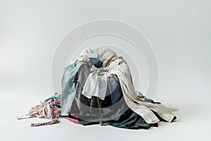 pile of various garments on grey