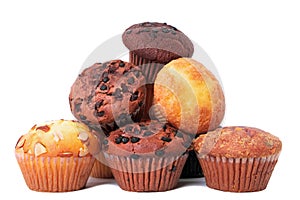 Pile of various muffin cup cakes isolated white background