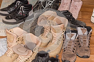 Pile of the various old worn footwear, fragment close-up