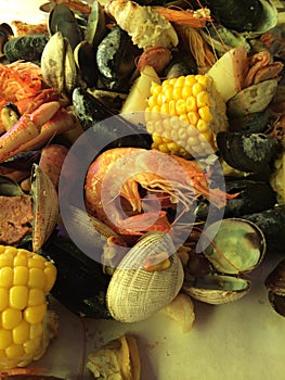 Pile of various shellfish and vegetables on a table