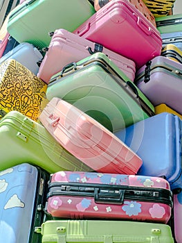 Pile of various styles of colourful suitcases