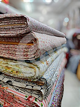 A pile of various textile materials ready for sale.