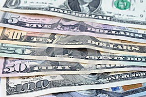 Pile of various US american dollar bills spread as pattern of ba