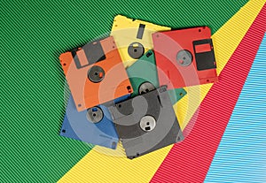 Pile of vintage floppy disks in multi-colored theme technology wallpaper
