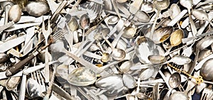 Pile of vintage silverware, spoons metal background