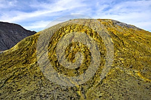 A pile of volcanic ash covered with sulfur