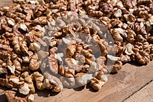 Pile of walnuts isolated on a wooden background