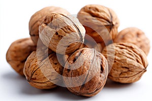 A pile of walnuts on a white surface