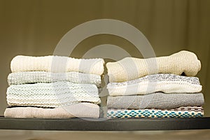 Pile of warm sweaters on a shelf