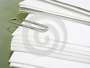 Pile of white bond paper with metal paper clip