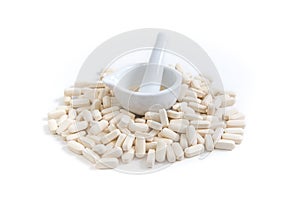 Pile of white tablets with a mortar and pestle