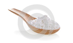 Pile of white wheat flour in wooden spoon